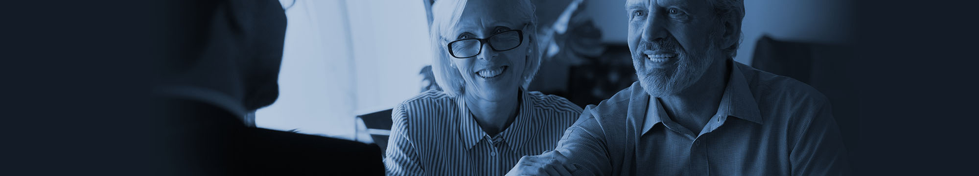 Female and male adults in conversation with a Funeral Planner.